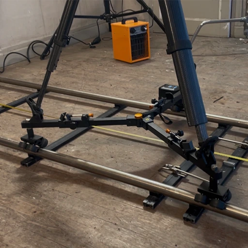 A motorized dolly and rail system designed to provide precise, repeatable camera movement for the URSA Cine Immersive camera.