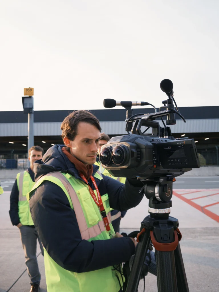 Rick Cosijn of Cinaglyph operating the Blackmagic URSA Cine Immersive camera system on an airport tarmac.